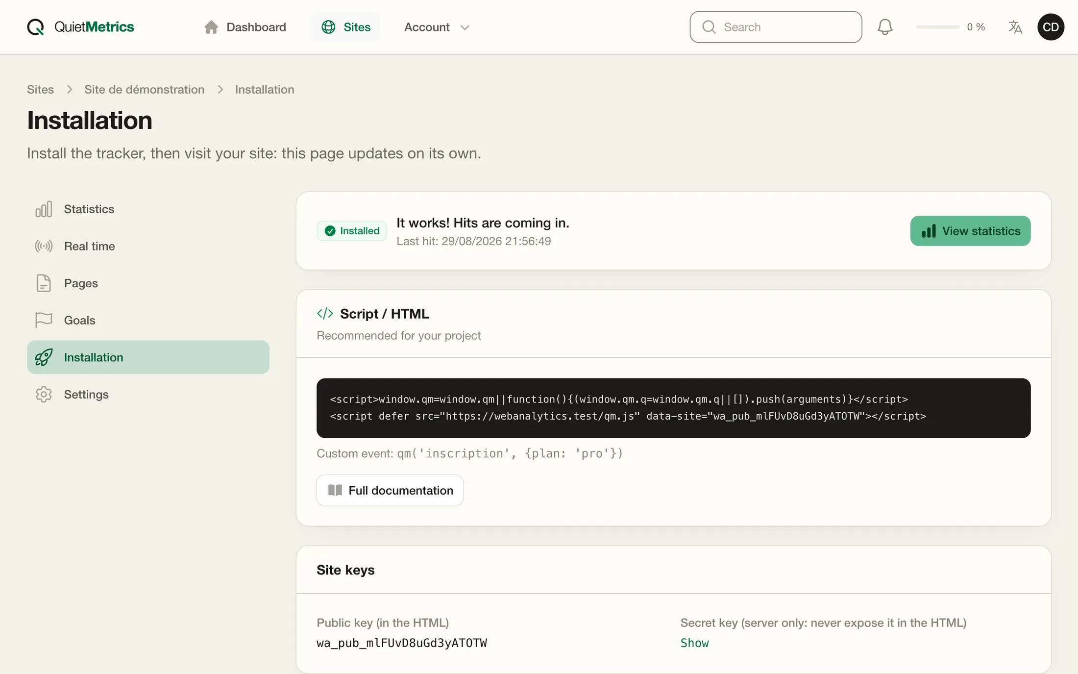The installation page of a site in Quiet Metrics: a confirmation that hits are arriving, the script to copy and the site keys.